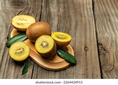 Closeup ripe golden kiwi fruit on wooden background. Healthy fruits concept. place for text, top view. - Powered by Shutterstock