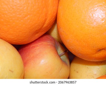 Closeup of ripe oranges and apples as a background with copy space