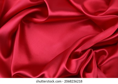 Closeup of rippled red silk fabric  - Shutterstock ID 2068236218