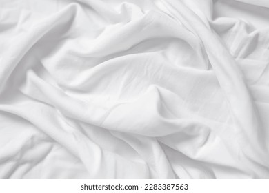 Closeup of rippled white silk fabric,white fabric draped in soft waves empty bed sheet - Shutterstock ID 2283387563
