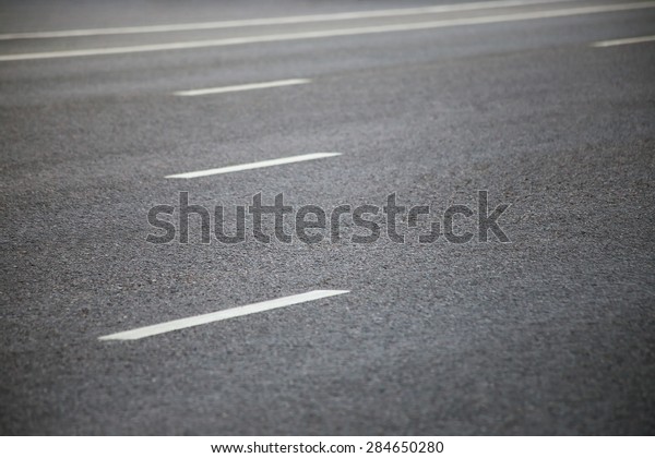 Closeup of the road with\
road marking