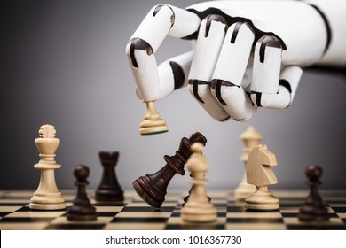 Close-up Of A Robot's Hand Playing Chess