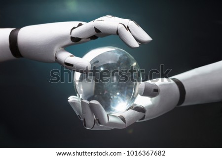 Close-up Of A Robot's Hand Predicting Future With Crystal Ball