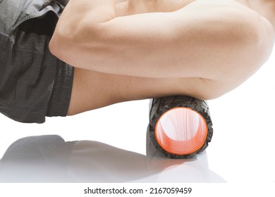 Close-up  Roller For Body Massage. Bald Guy Doing An Exercise  With Foam Roller On His Upper Back Against White Background.