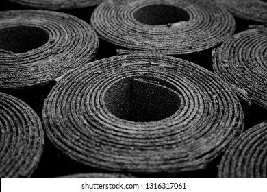 Closeup Of Rolls Of New Black Roofing Felt Or Bitumen. Shallow Depth Off Field