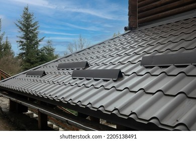 Closeup Roof With Metal Grey Shingle Tiling Surface With Rain Gutter Pipe And Snow Guard Protective Fence