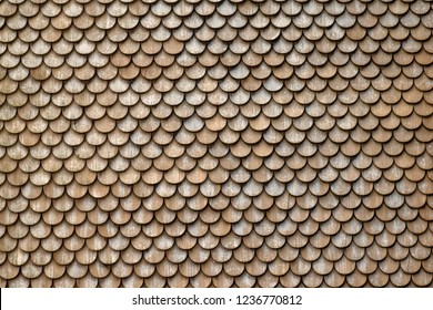Closeup of a roof of a Swiss farm, covered with round wooden shingle tiles