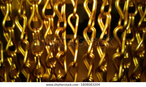 Closeup of a room\
divider in metallic\
gold