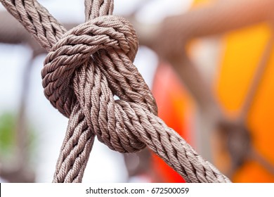 Close-up of rope knot line tied together with playground background - Powered by Shutterstock