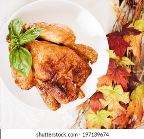 A Close-up Of A Rotisserie Chicken On A Plate.