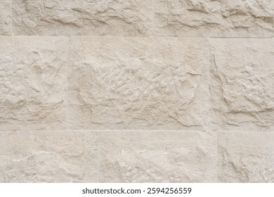 Close-up of a rough stone surface with light patches and unique texture. Detailed shot of a weathered stone surface with light spots and intricate patterns.