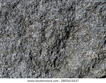 Close-up of roughcast wall texture with rugged cement plaster surface. High-resolution abstract construction background, weathered concrete finish, seamless exterior wall texture.