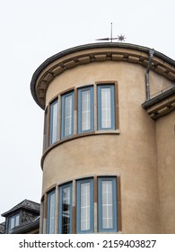 A closeup of a round building with cloudless sky background