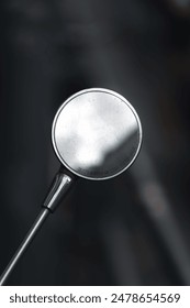 A close-up of a round side mirror with the text 'Objects in mirror are closer than they appear'