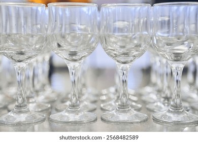 Close-up of a row of empty, transparent, clean wine glasses. With space to copy. High quality photo