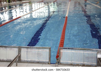 Closeup Of The Row Of Lanes In The Swimming Pool. Diving Board