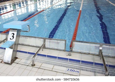 Closeup Of The Row Of Lanes In The Swimming Pool. Diving Board