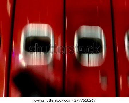 Close-up of Row of Red Office Ring Binders with Metal Finger Pull Holes