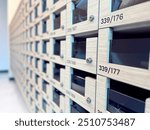 Close-up of a row of wooden mailboxes or lockers, showcasing modern design and organizational structure. Perfect for illustrating themes of security, organization, and residential or office environmen