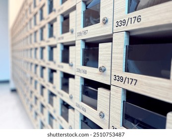 Close-up of a row of wooden mailboxes or lockers, showcasing modern design and organizational structure. Perfect for illustrating themes of security, organization, and residential or office environmen - Powered by Shutterstock