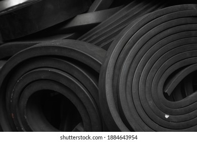 Close-up rubber sealing strips for waterproof doors. A pile of rubber twisted into rolls.