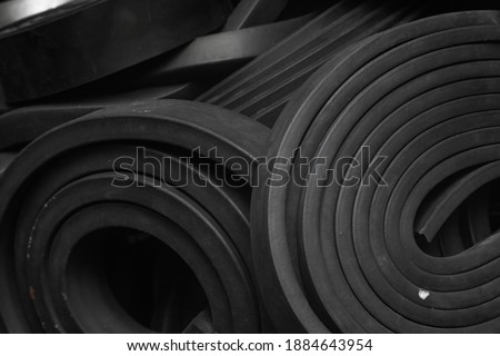 Close-up rubber sealing strips for waterproof doors. A pile of rubber twisted into rolls.