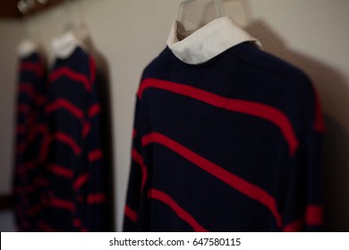 Close-up of rugby shirts hanging in locker room - Powered by Shutterstock