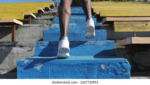 Close-up Run Up The Stairs. Black Man Trains At The Stadium. 