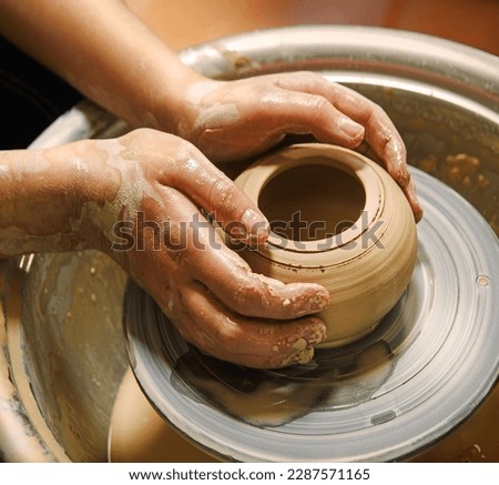 Closeup rural bible god male artisan worker dirty arm touch tool teach ancient retro old earthen culture water mug pitcher vessel ware. Rustic antique wet hobby table girl learn make pan dish design