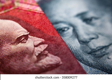 Close-up Of An Russian Ruble Bill (showing Lenin) And A Chinese Yuan Banknote (Mao Zedong)