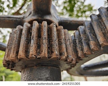 Close-up of rusted gears of a sluice mechanism from an outdoor installation. It was exposed to wind and rain, so it must have rusted. Just like a person who works hard, there will be traces of time.