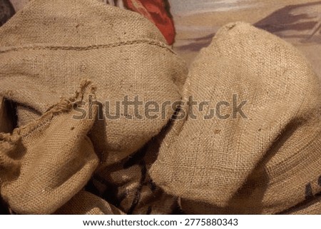 Close-up of rustic brown burlap sacks made of natural jute fiber texture, often used for agricultural storage like coffee beans or rice.