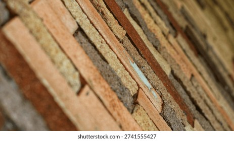 Close-up of rustic exposed brick wall texture with natural earth tone colours. Horizontal brick pattern with rough surface detail, perfect for background, architecture, construction, and design projects.