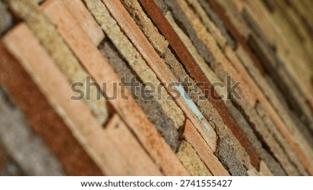 Close-up of rustic exposed brick wall texture with natural earth tone colours. Horizontal brick pattern with rough surface detail, perfect for background, architecture, construction, and design projects.