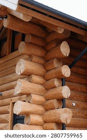 A close-up of a rustic log cabin corner showcasing interlocking wooden logs and craftsmanship.