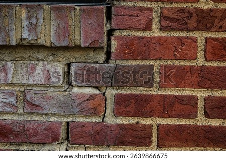 close-up of a rustic red brick building facade detail. abstract beauty in architecture. construction tuckpointing concept. crack in wall.