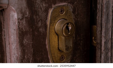 Close-up of a rustic wooden door with metal handles showing signs of wear and rust. The aged texture of the wood contrasts with the metallic sheen, creating a blend of vintage charm and industrial str - Powered by Shutterstock