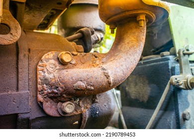 Close-up Rusty Cooker Exhaust Pipe Of A Walk-behind Tractor Attached To A Walk-behind Tractor Engine. Repair And Restoration Of Agricultural Machinery