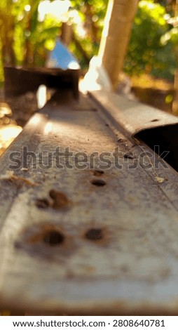 Close-up of a rusty metal surface with shallow depth of field, highlighting corrosion, weathering, and industrial texture.
