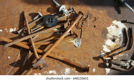 Close-up Of Rusty Nails And Other Small Things. Abstract Metal Background