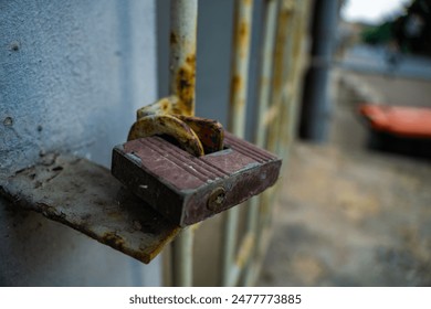 Close-Up of a Rusty Padlock Securing a Metal Gate. limited access internet security Concept no entry secret - Powered by Shutterstock