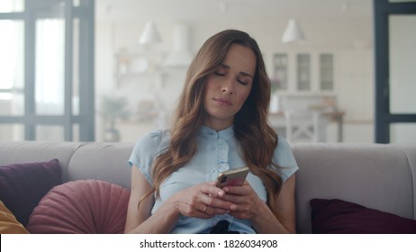 Closeup Sad Face Woman Reading Phone Message At Home Office. Portrait Of Business Woman Chatting Mobile Phone In Slow Motion. Freelancer Girl Getting Bad News On Cellphone On Couch.