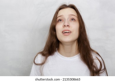 Closeup Sad Woman Crying On Light Background. Close Up Crying Girl Face In Studio