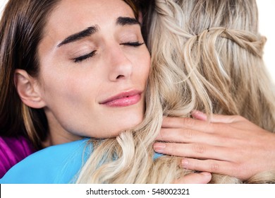 Close-up Of Sad Woman Hugging Friend