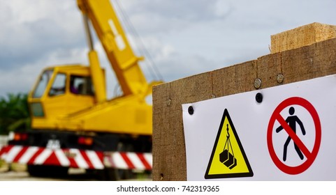 Closeup of safety signage with blur background of mobile crane at construction site - Shutterstock ID 742319365