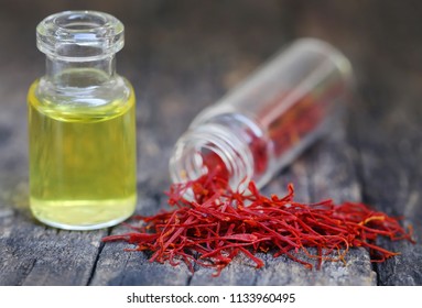 Closeup Of Saffron With Extract In A Bottle On Natural Surface