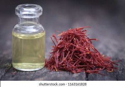 Closeup Of Saffron With Extract In A Bottle On Natural Surface