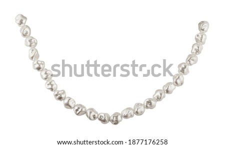 Closeup of sagging string of baroque pearls isolated on white background