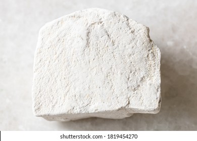 closeup of sample of natural mineral from geological collection - unpolished Chalk stone on white marble background from Voronezh region, Russia - Shutterstock ID 1819454270