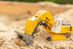 Close-up Of A Sand Toy Digger In A Sandbox